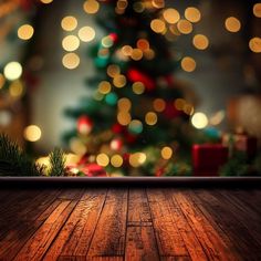 a christmas tree with lights in the background and a wooden floor that has been decorated