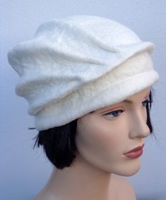 a mannequin head wearing a white hat