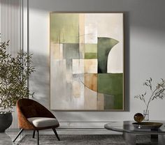 an abstract painting hangs on the wall next to a chair and coffee table in a modern living room