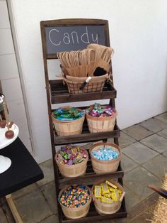 a wooden stand with baskets and candy on it