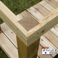 a wooden bench sitting on top of a lush green field