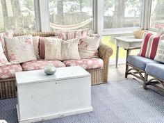 a living room filled with furniture and lots of windows