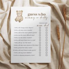 a question card with a teddy bear on it sitting next to some brown wheat stalks