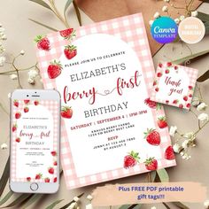 a pink and white checkered birthday card with strawberries on it, next to an iphone