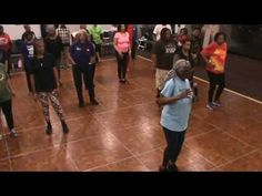 a group of people standing on top of a dance floor