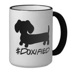 a black and white coffee mug with a dachshund dog on it's side