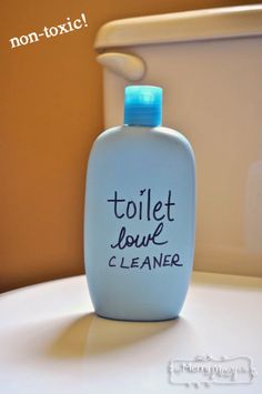 a white toilet with a blue lid and a bottle that says toilet love cleaner on it