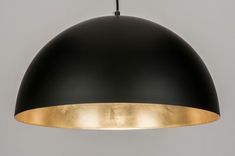 a black and gold pendant light hanging from a ceiling