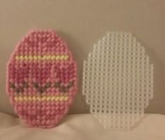 two small pieces of art made out of perler beads, each with a face on it