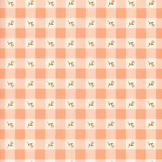 an orange and white checkered fabric with small green leaves