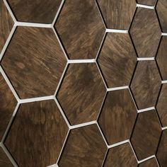 a wooden wall with hexagonal tiles on the side and white lines running through it