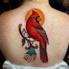 a woman with a red bird tattoo on her back