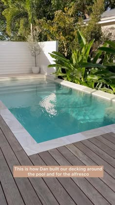 an empty pool in the middle of a wooden deck