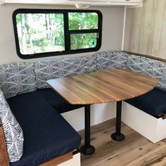 a table and bench in front of a window