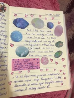 an open notebook with writing on it and pictures of planets in the pages, along with hearts