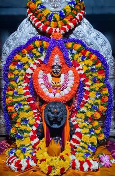 the statue is decorated with flowers and other decorations