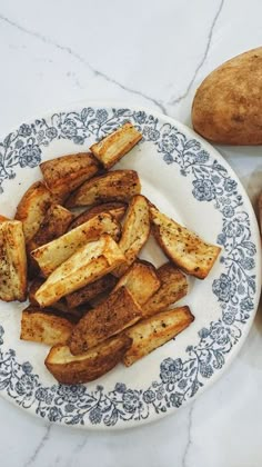 some potatoes are sitting on a plate next to another potato