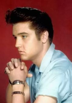 a close up of a person with his hands clasped in front of their chins