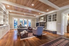 a living room filled with furniture and a fire place in the middle of a room