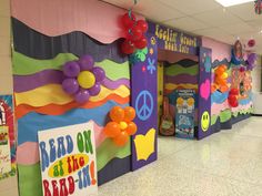 colorful bulletin boards with peace signs and balloons on them in a school hallway decorated for the day of the dead