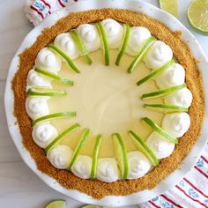 a pie with green apples and marshmallows in the middle on a white plate