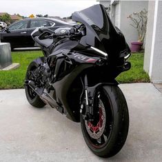 a black motorcycle parked in front of a house