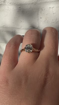 a person's hand with a ring on it