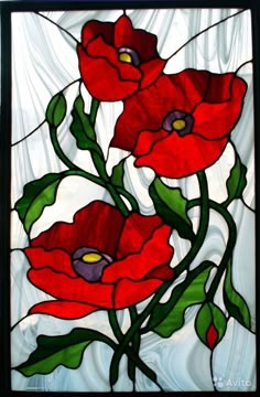 a stained glass window with red flowers and green leaves on the bottom, against a white background