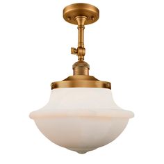 an antique brass finish ceiling light with white glass globe shade on the front and side