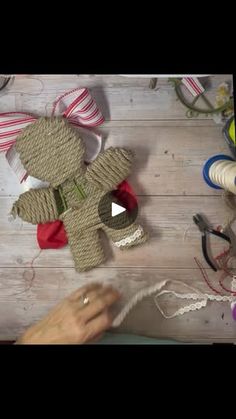 someone is working with yarn to make a teddy bear ornament on the table