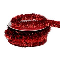 a red tinsel covered cake sitting on top of a white plate