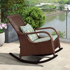 a brown rocking chair sitting on top of a patio