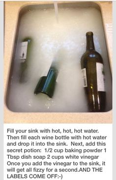 a bottle of wine sitting in a bathtub filled with water on top of a counter