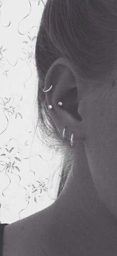 black and white photograph of woman with ear piercings