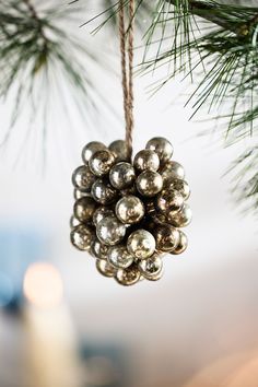 a christmas ornament hanging from a pine tree