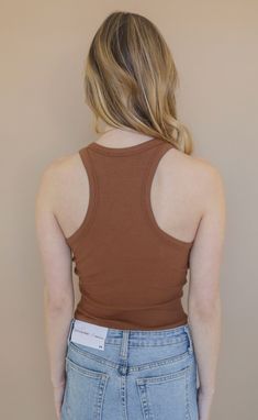 Working on a capsule closet? Be sure to add this basic! This fitted, racerback tank comes in a chocolate brown that can be worn alone or layered season after season. Lili is 5'6" and is wearing size extra small extra small measurements: 29" bust | 18" length 95% rayon | 4% elastane PRODUCTS ON SALE ARE FINAL SALE! Feel free to email us at orders@shopriffraff.com or DM us with any questions regarding fit, styling, or our return policy in general. Spring Stretch Brown Tank Top, Brown Stretch Tank Top For Spring, Spring Brown Stretch Tank Top, Fitted Brown Tank Top For Fall, Brown Fitted Tank Top, Trendy Fitted Brown Tank Top, Brown Tank Top For Fall, Brown Stretch Tank Top, Casual Brown Stretch Tank Top