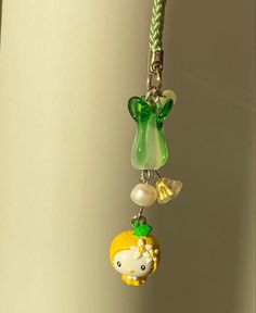 a keychain hanging from the side of a wall with charms attached to it