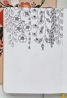 an open notebook with floral designs on it