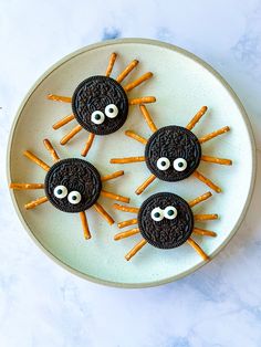 three oreo cookies with eyes on them in the shape of spider's legs