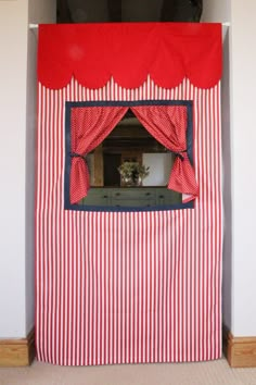 a red and white striped room with a window