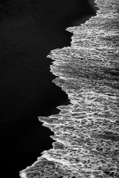 black and white photograph of waves on the beach