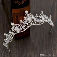 a tiara on a wooden table next to a bottle