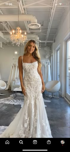 a woman in a wedding dress posing for the camera