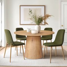 a dining room table with green chairs around it