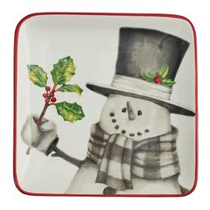 a plate with a snowman holding a holly berry