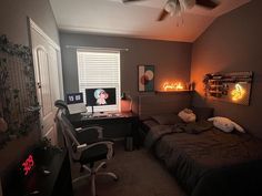 a bed room with a neatly made bed and a desk in front of a window