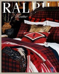 a bed with red, black and white plaid comforter on it's cover