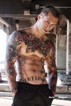 a man with lots of tattoos on his chest