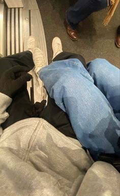 two people are laying on the floor with their feet propped up in front of them