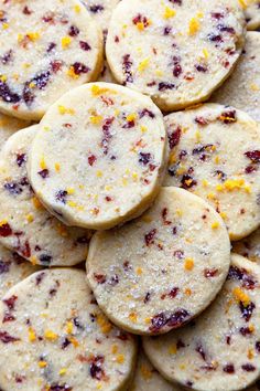 cranberry orange shortbread cookies are piled on top of each other